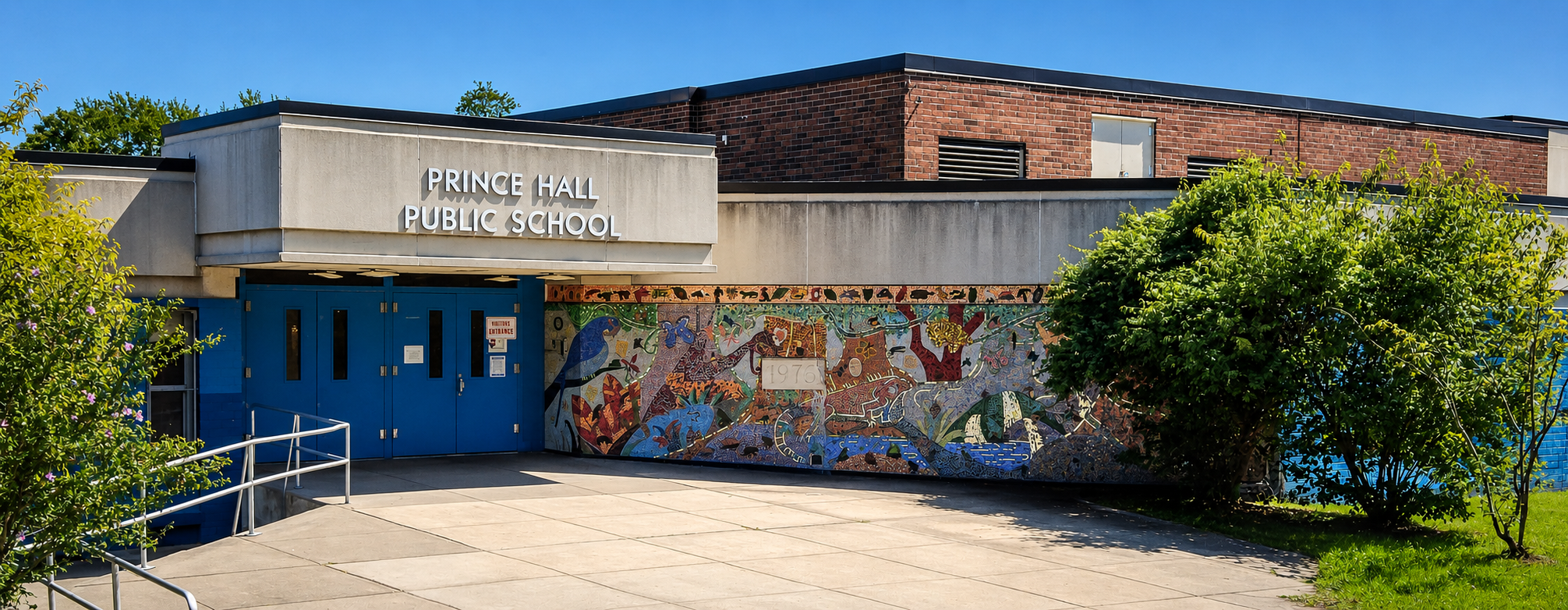 Prince Hall Public School Entrance Exterior entrance of Prince Hall Public School with blue doors and a colorful mosaic mural.